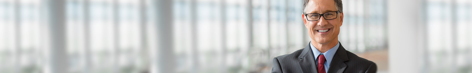 businessman standing in office smiling